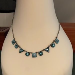 Turquoise gems on silver chain.  Matching flat earrings.